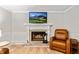 Living room fireplace and brick hearth adds a warm touch with a comfortable chair at 135 Crimson Rdg, Tyrone, GA 30290