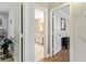 Hallway view leading to a bathroom and other rooms, showcasing the home's layout at 135 Crimson Rdg, Tyrone, GA 30290