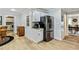 Kitchen featuring white cabinets, granite countertops, stainless steel refrigerator, and adjacent dining area at 135 Crimson Rdg, Tyrone, GA 30290