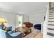 Cozy living room with a brown leather sofa, blue beanbag and chairs, and a patterned rug at 135 Crimson Rdg, Tyrone, GA 30290