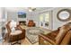 Inviting living room with a fireplace, French doors, and leather seating at 135 Crimson Rdg, Tyrone, GA 30290