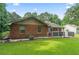 View of the back exterior of the brick home with patio and well-maintained lawn at 1738 Sherry Ln, Jonesboro, GA 30236