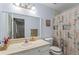 Neutral bathroom with framed mirror, vanity, toilet, and shower with patterned curtain at 1738 Sherry Ln, Jonesboro, GA 30236
