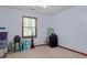 Bedroom with beige carpet, ceiling fan and window, filled with packed boxes at 1738 Sherry Ln, Jonesboro, GA 30236