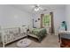 Bright bedroom with natural light, ceiling fan, colorful bedding and a crib at 1738 Sherry Ln, Jonesboro, GA 30236