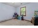Spacious bedroom featuring carpet, neutral colors, and a window with natural light at 1738 Sherry Ln, Jonesboro, GA 30236