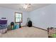 Spacious bedroom with beige carpet, fan and window, filled with packed boxes at 1738 Sherry Ln, Jonesboro, GA 30236