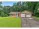 Charming single story brick home with a two car garage, large lawn, and mature shade trees at 1738 Sherry Ln, Jonesboro, GA 30236