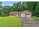 Charming brick ranch-style home featuring a two-car garage and a well-manicured front lawn at 1738 Sherry Ln, Jonesboro, GA 30236