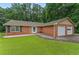 A well-maintained brick home with a two-car garage and lush green lawn offers suburban charm at 1738 Sherry Ln, Jonesboro, GA 30236