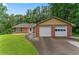 Charming brick ranch-style home featuring a two-car garage and a well-manicured front lawn at 1738 Sherry Ln, Jonesboro, GA 30236