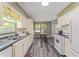 Galley style kitchen features white cabinets, sleek countertops and modern flooring at 1738 Sherry Ln, Jonesboro, GA 30236