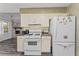 Bright kitchen featuring white appliances and a view into the living room at 1738 Sherry Ln, Jonesboro, GA 30236
