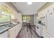 Well-lit kitchen featuring white cabinets and appliances with sleek countertops at 1738 Sherry Ln, Jonesboro, GA 30236