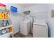 Functional laundry room with washer, dryer, storage shelves and vinyl flooring at 1738 Sherry Ln, Jonesboro, GA 30236