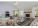 Cozy living area with a brick fireplace, wood floors and access to an adjacent dining area at 1738 Sherry Ln, Jonesboro, GA 30236