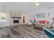 Cozy living room features a brick fireplace, wood floors and ample seating at 1738 Sherry Ln, Jonesboro, GA 30236