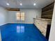 Finished basement bar area featuring a stone counter, multicolored wood accent wall, and sealed concrete flooring at 3499 Lake Mill Rd, Buford, GA 30519