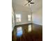 Bright bedroom with hardwood floors, ceiling fan, and large windows at 3499 Lake Mill Rd, Buford, GA 30519