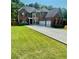 Charming two-story brick home with a well-manicured lawn and a spacious driveway leading to a three-car garage at 3499 Lake Mill Rd, Buford, GA 30519