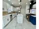 Contemporary kitchen with a center island, stainless appliances, and white cabinetry at 3499 Lake Mill Rd, Buford, GA 30519