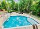 Tranquil backyard oasis with a large in-ground pool, stone accents, and luxurious lounge area at 3499 Lake Mill Rd, Buford, GA 30519