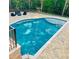 Backyard pool with lush landscaping, outdoor seating, and stone paver deck, perfect for relaxation and entertainment at 3499 Lake Mill Rd, Buford, GA 30519