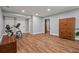 Finished basement space features wood-look floors, neutral paint, and exercise equipment at 970 Pine Grove Pointe Dr, Roswell, GA 30075