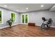 Spacious basement featuring hardwood floors, natural light, and an exercise area, great for recreation at 970 Pine Grove Pointe Dr, Roswell, GA 30075