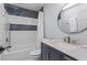 Contemporary bathroom with a tub-shower combo, elegant marble countertop, and navy blue vanity at 970 Pine Grove Pointe Dr, Roswell, GA 30075