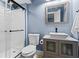 Modern bathroom features framed mirror, floating vanity, and glass enclosed shower at 970 Pine Grove Pointe Dr, Roswell, GA 30075
