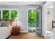 Bright bedroom with hardwood floors, a walk-out balcony, and an attached bathroom with glass shower at 970 Pine Grove Pointe Dr, Roswell, GA 30075