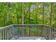 Inviting outdoor deck surrounded by lush green trees and a comfortable seating area at 970 Pine Grove Pointe Dr, Roswell, GA 30075
