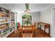 Formal dining room features hardwood floors, built-in shelving, and a stunning window overlooking the lush backyard at 970 Pine Grove Pointe Dr, Roswell, GA 30075