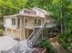 Back of house features large wooden deck and staircase leading to the driveway at 970 Pine Grove Pointe Dr, Roswell, GA 30075