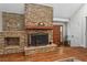 Elegant fireplace with stone surround and hardwood flooring at 970 Pine Grove Pointe Dr, Roswell, GA 30075