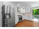Updated kitchen with stainless steel appliances, white cabinets and hardwood floors is a home chef's dream at 970 Pine Grove Pointe Dr, Roswell, GA 30075