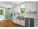 Bright kitchen features stainless steel appliances, farmhouse sink, subway tile, and a view of the wooded backyard at 970 Pine Grove Pointe Dr, Roswell, GA 30075