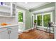 Charming breakfast nook with white cabinets and large windows offers a delightful spot to enjoy your morning coffee at 970 Pine Grove Pointe Dr, Roswell, GA 30075