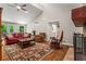 Spacious living room with a vaulted ceiling, stone fireplace, and outside access at 970 Pine Grove Pointe Dr, Roswell, GA 30075