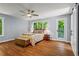 Main bedroom with private balcony access, hardwood floors, ensuite bathroom and large windows with wooded views at 970 Pine Grove Pointe Dr, Roswell, GA 30075