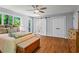 Spacious bedroom with private balcony, hardwood floors and ensuite bathroom at 970 Pine Grove Pointe Dr, Roswell, GA 30075