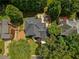 Expansive aerial view of a home with a large backyard deck and mature trees providing shade and privacy at 9975 Groomsbridge Rd, Johns Creek, GA 30022