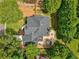 Overhead aerial view highlighting the home's architectural design, spacious backyard deck, and meticulously kept lawn at 9975 Groomsbridge Rd, Johns Creek, GA 30022