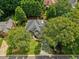 Beautiful aerial view of a home surrounded by lush greenery, showcasing its prime location and landscaped grounds at 9975 Groomsbridge Rd, Johns Creek, GA 30022