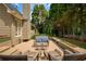A cozy outdoor seating area on the back deck offers a peaceful view of the wooded backyard at 9975 Groomsbridge Rd, Johns Creek, GA 30022
