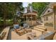 Inviting back deck with a gazebo and plenty of seating perfect for entertaining and relaxing outdoors at 9975 Groomsbridge Rd, Johns Creek, GA 30022
