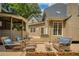 Inviting back deck with wicker seating, planter boxes, and access to a screened-in porch, perfect for outdoor relaxation at 9975 Groomsbridge Rd, Johns Creek, GA 30022