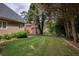 The level backyard features lush greenery, a private fence, and a tree line, offering a serene and secluded outdoor space at 9975 Groomsbridge Rd, Johns Creek, GA 30022