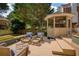 Backyard deck featuring a gazebo and multiple seating areas with comfortable cushions at 9975 Groomsbridge Rd, Johns Creek, GA 30022